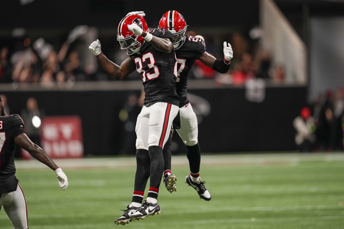 Nov 26, 2023; Atlanta, Georgia, USA; Atlanta Falcons defensive tackle Calais Campbell (93) and safety Richie Grant (27) react after defeating the New Orleans Saints at Mercedes-Benz Stadium.  